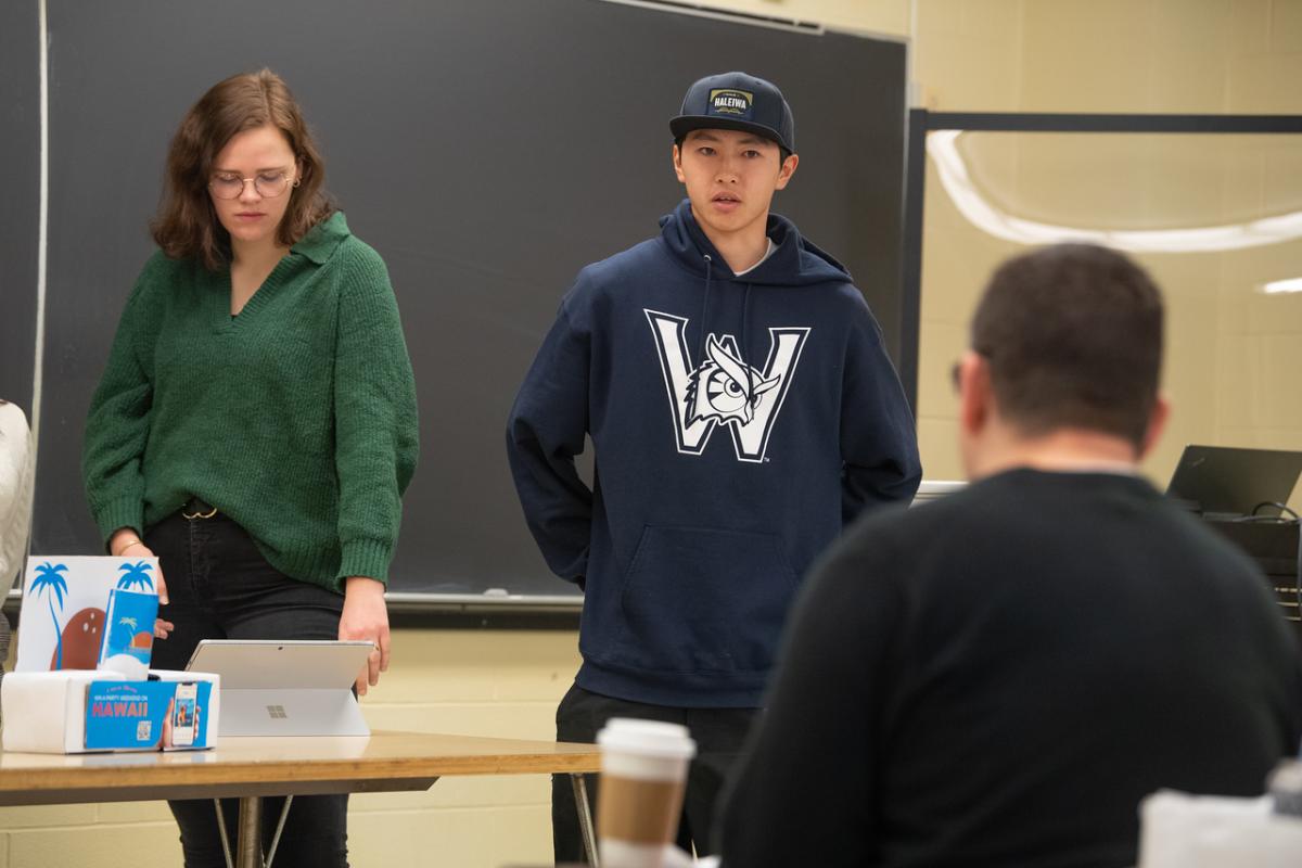 Two students giving a presentation in a classroom.