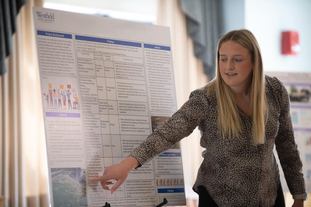 Student presenting research poster.