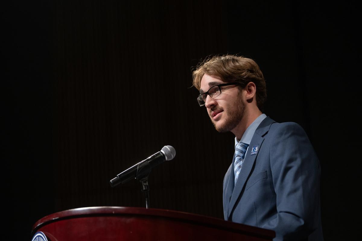 Political science student delivering a speech at a podium.