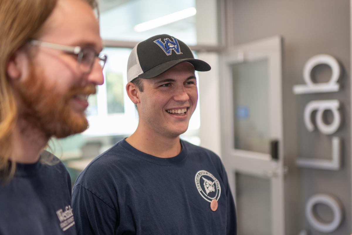 Student smiling at campus open house event.