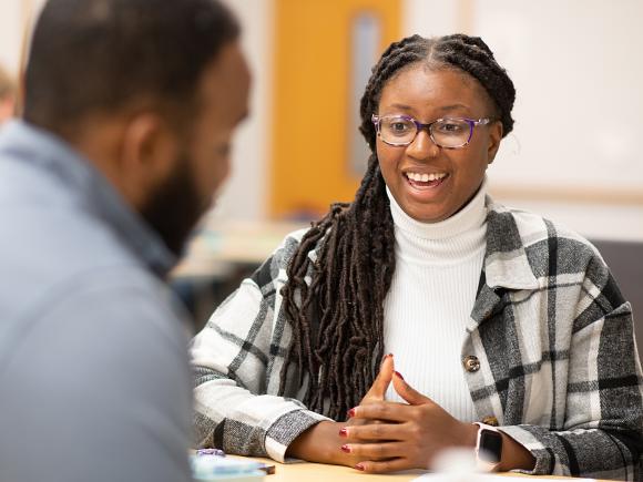 MPA student smiles at classmate.