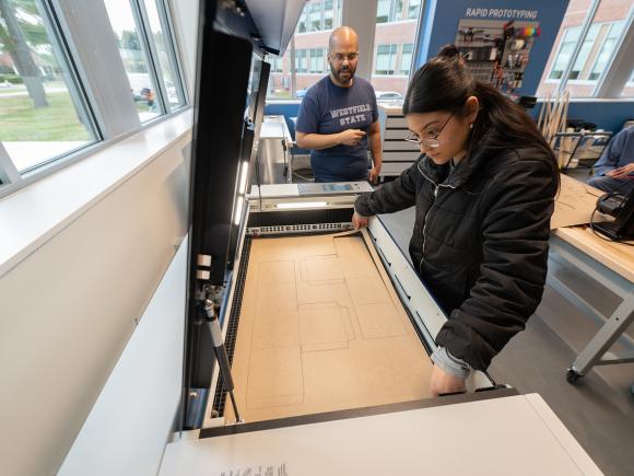Student working with a professor in the RIDE Center.
