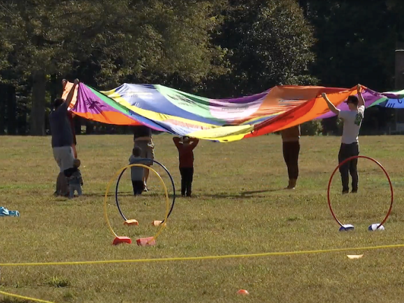 People at the 12th 5k Stanley Park Run playing with colorful hoola hoops and various apparatus as part of a yearly fundraising effort for the Frank Stanley Beveridge Wildlife Sanctuary.
