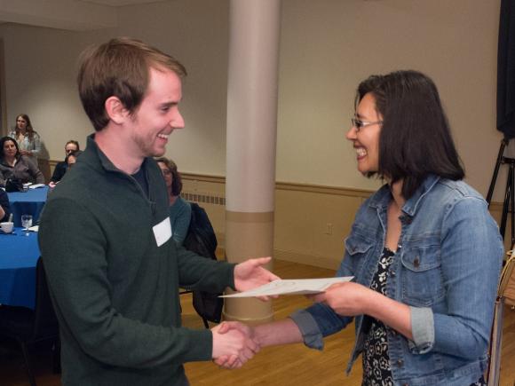 School counseling student shaking a faculty members hand.