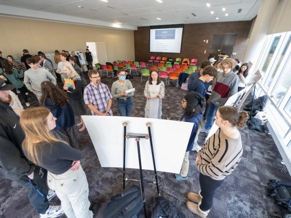 Students presenting a poster board and their idea as part of Discover Westfield's Shark Tank event.