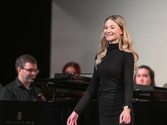 Student smiling at vocal recital.