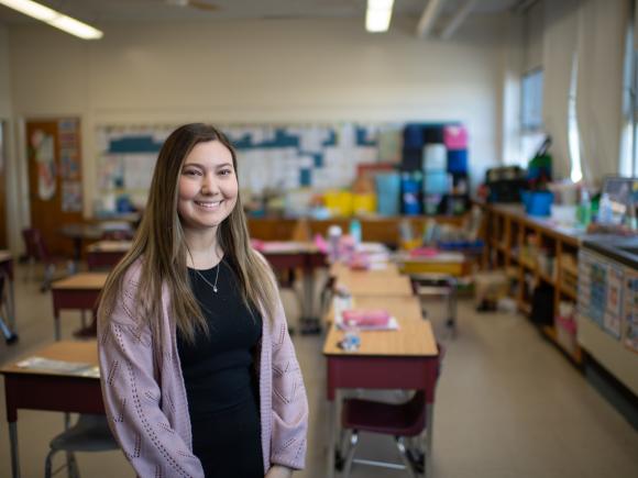 Student intern smiling in an elementary school.