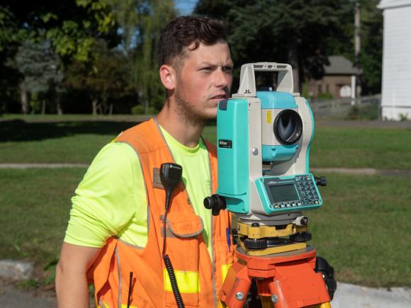 Student conducts a site survey to improve water runoff flow to the Westfield River.