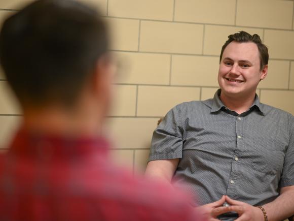 Counseling graduate student leading a therapy session with a client.