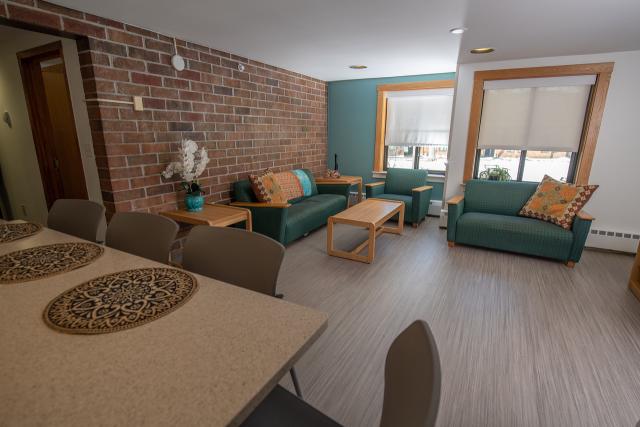 Welch Hall Apartment Complex with blue couches and counter bar.