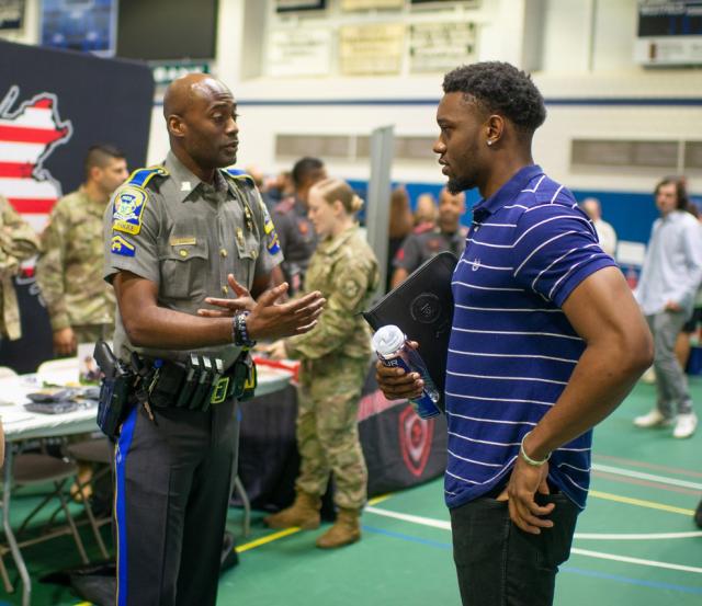 Criminal Justice student at career fair speaking with an employer.