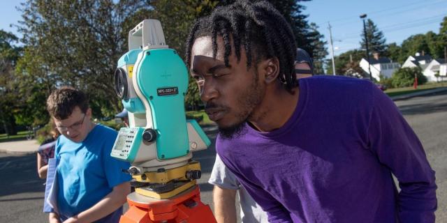 Westfield State student surveys a parking lot in town.