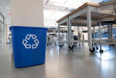 Blue recycling bin a classroom.