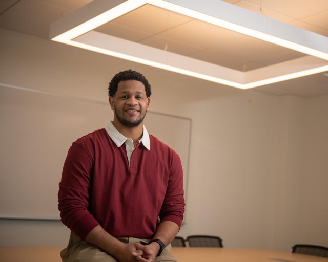 Mathematics student smiling in a classroom.