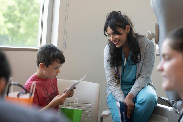 Student smiling while engaged in a hands-on activity in the simulation lab.