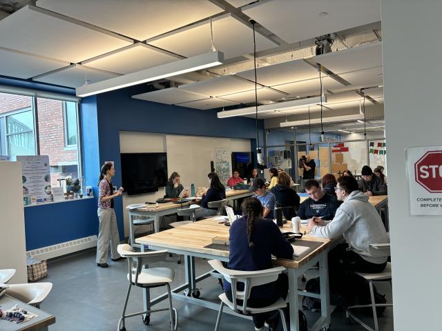 Students seated at tables for a criminal justice forensics event.
