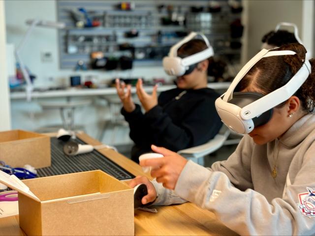 two students utilizing VR goggles in RIDE Center
