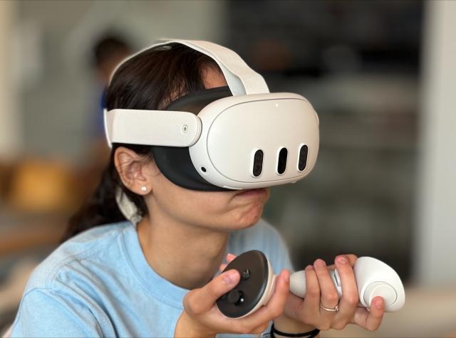 student utilizing VR goggles in RIDE Center