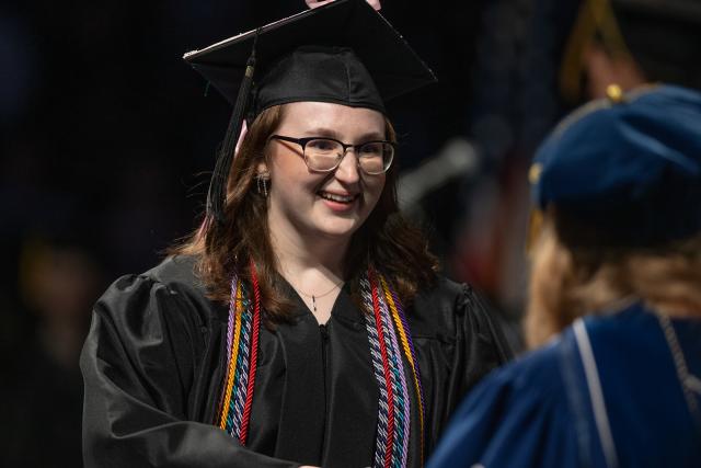 Accounting student smiling at graduation ceremony.