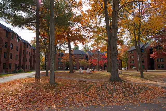 Apartment Complex arranged in a horseshoe shape, surrounded by fall foliage.