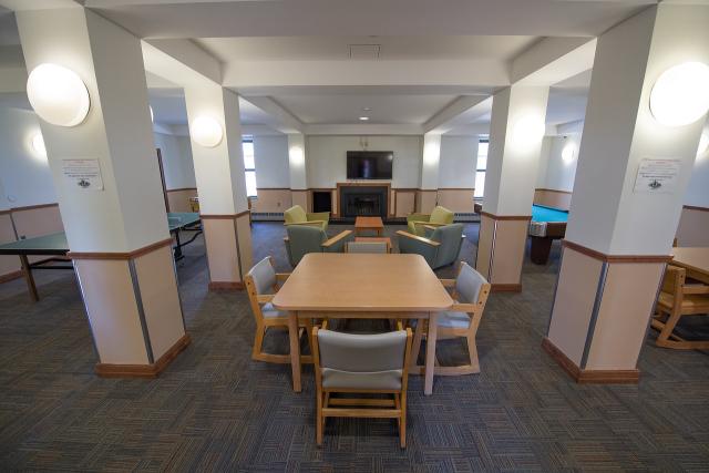 Courtney Hall lounge showcasing tables with chairs and couches.