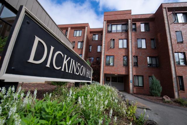 Exterior of Dickinson Hall with building sign in front.