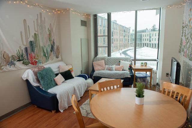 Interior of a New Hall apartment showing a living area with a large bay window.