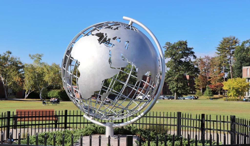 Campus globe with blue skies behind it.