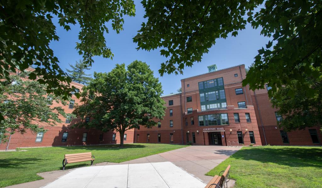 Courtney Hall exterior framed by trees on the Westfield State University campus.