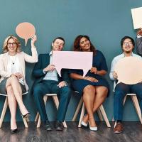 Employees seated and holding comment bubbles.