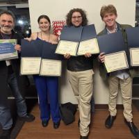 Faculty member and students holding awards at the Region 1 Kennedy Center American College Theatre Festival (KCACTF).