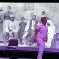 Woman performs on stage in front of black and white image of African Americans in the 19th century
